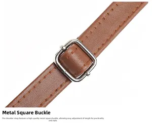 Detail of adjustable silver square buckle on brown lychee texture leather shoulder strap
