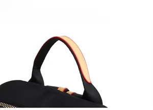 Detail of comfortable black nylon handle with tan leather lining and gold zipper accents