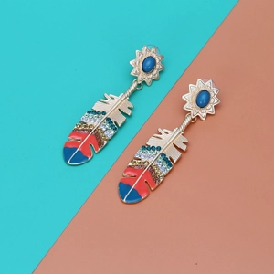 Detailed close-up of bohemian feather drop earrings with colorful rhinestones and enamel