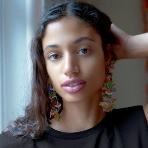Handmade floral tassel earrings with colorful beads and 925 silver needles worn by a model