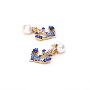 Golden anchor drop earrings with colorful rhinestones and white pearls on white background