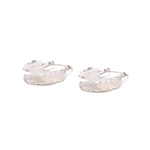 Macro detail of silver hoop earrings featuring a handcrafted hammered leaf texture finish