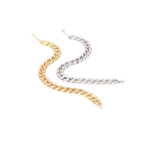 Detail of chunky gold and silver curb chain necklaces with lobster clasp closure