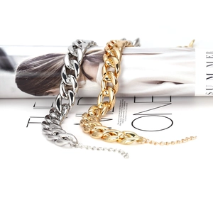 Chunky gold and silver plated link chain necklaces shown with trendy magazine prop