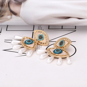 Bohemian Evil Eye earrings with blue crystals and hanging white pearl teardrops