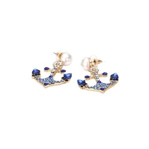 Creative gold anchor earrings with blue gradient crystals and pearl accents on white background