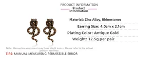 Detailed view of vintage gold cobra earrings with brown rhinestones and dimensions