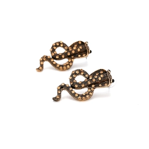 Vintage gold cobra snake earrings encrusted with sparkling amber rhinestones on white background