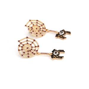 Gothic spider web earrings with purple crystals and spider drop on white background