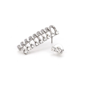 Detailed view of silver C-shaped crawler earrings and studs with sparkling crystals