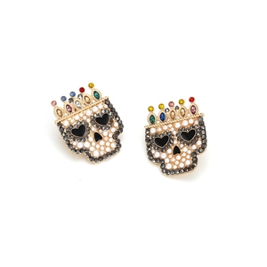 Detailed view of Baroque skull earrings with colorful crown rhinestones and small white pearls