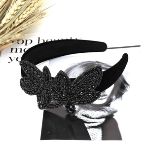 Baroque wide black velvet headband with handmade beadwork on a fashion magazine