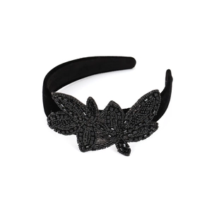 Detail view of handmade black velvet headband with intricate beaded butterfly embellishments