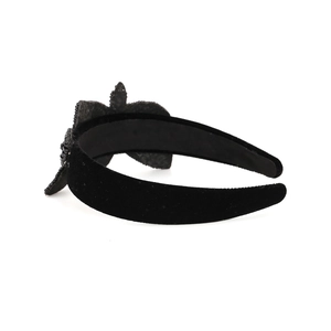 Baroque black velvet headband with a large handcrafted beaded bow in a side view profile