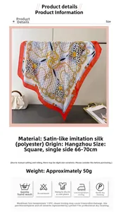 Macro detail of satin silk scarf featuring luxury chain and heart patterns with washing icons