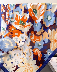 Nahaufnahme des Seidenschals mit Blumenmuster zeigt luxuriöse Textur und satte Farben