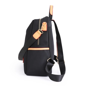 Fashionable black water-resistant nylon backpack with stylish brown leather trim details