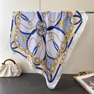 Detailed shot of luxurious silk scarf with gold chain print and leopard pattern texture