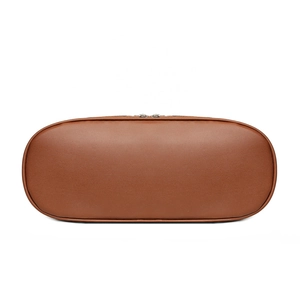 Bottom view of large vintage caramel brown leather handbag with oval base and fine stitching