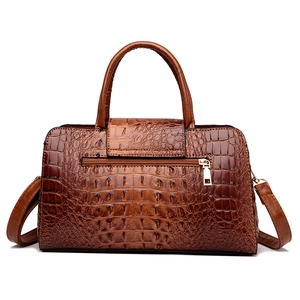Deep brown crocodile embossed leather handbag with top handles and adjustable strap