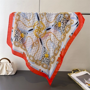 Red silk satin square scarf featuring golden chain print and leopard pattern design