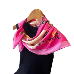 Luxurious chain print faux silk square scarf in pink and white displayed on a hanger
