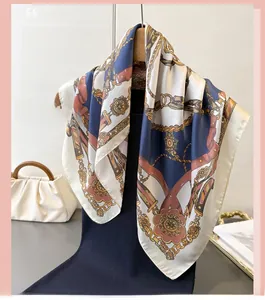 Detail of luxury satin silk scarf featuring vintage chain prints and classic crest patterns