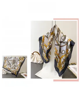 Detailed macro view of vintage chain and belt printed silk scarf with elegant drape