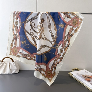 Detail of vintage floral silk scarf with chain print draped over a metal rod holder
