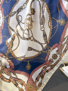 Detail of silk-like scarf with vintage chain and harness prints in navy and burgundy
