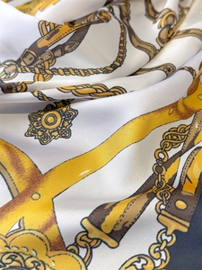 Detailed close-up of retro baroque print silk scarf showing soft fabric folds and chain motifs