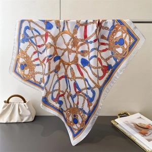 Detail of vintage chain and tassel print silk scarf with luxury satin finish