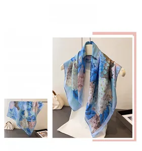 Macro detail of sky blue silk scarf featuring elegant hydrangea floral patterns