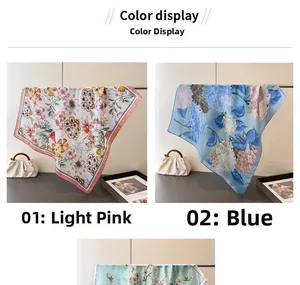 Detail view of floral print silk scarves in light pink and blue hydrangea patterns