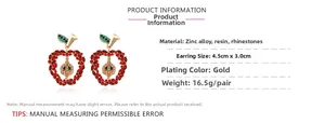 Detailed view of red rhinestone apple earrings with gold base and size measurements