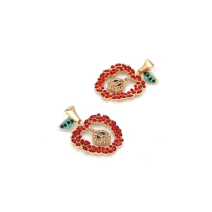 Creative apple-shaped dangle earrings with red and champagne rhinestones on a white base