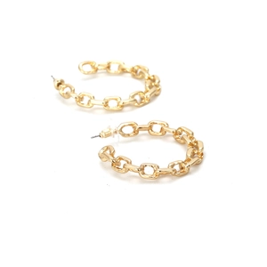 Detailed view of chunky gold chain link earrings in a geometric C-shape design