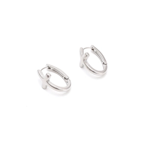 Macro detail of silver-toned minimalist X-shaped huggie earrings with a polished finish