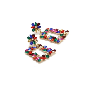 Detailed macro view of vintage gold hollow earrings with colorful marquise rhinestones