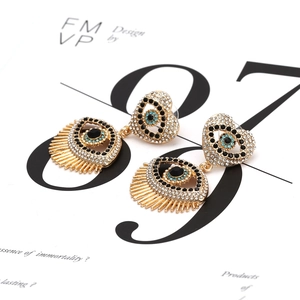 Gold-plated heart-shaped evil eye drop earrings with sparkling rhinestones and lashes