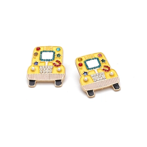 Detailed macro view of yellow enamel bus earrings with colorful crystals and pearls