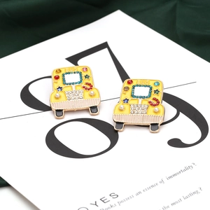Vibrant yellow school bus stud earrings with sparkling rhinestones and pearl accents