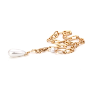 Detail of gold chunky chain necklace featuring large baroque pearl drop and lobster clasp