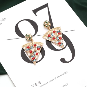 Detailed macro view of creative pizza slice earrings with colorful crystal rhinestones