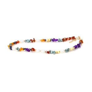Detail of bohemian necklace with colorful natural stone chips and white pearls