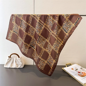 Detail of silk square scarf featuring vintage gold chain and leopard print patterns