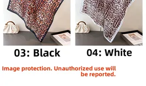 Close-up of leopard print satin scarves in black and white styles with smooth texture