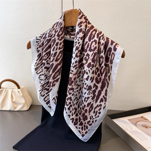Elegant leopard print silk scarf styled as a neckerchief with a white border