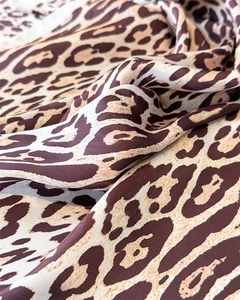 Close-up of leopard print satin scarf showing silky texture and elegant fabric folds