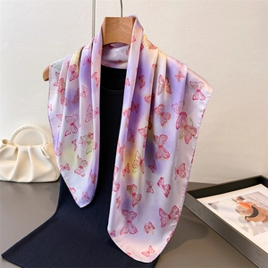 Elegant butterfly print satin scarf featuring purple gradient silk texture on a wooden hanger